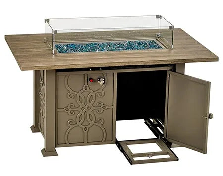  A rectangular gas fire pit table with a glass top and a metal frame. The table has two doors with intricate metal detailing, and a red control button is visible. The table has a wooden-look top and blue fire glass inside.