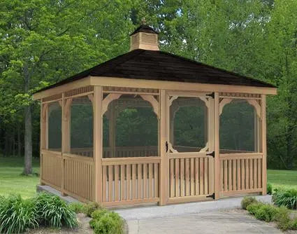 A rectangular, wooden screened gazebo with a peaked roof and screened walls. The gazebo has a door and is surrounded by greenery.