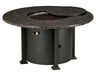  A round fire pit table with a granite top and a black metal base. The table has a circular burner and a control panel with a knob and a switch. A granite lid covers the burner, and a door on the side of the base reveals a storage compartment.