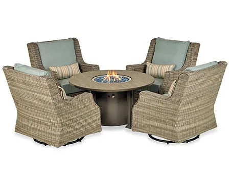 A round gas fire pit table with a wooden top and a bronze-colored base. The fire pit has blue flames and glass fire beads. A door on the side of the base is open, revealing a storage compartment.