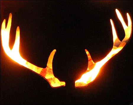  A pair of deer antlers silhouetted against a dark background. The antlers are illuminated from behind, creating a fiery glow.