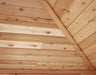  A close-up of a cedar tongue and groove ceiling with a vaulted pattern, showing the natural wood grain and color variations.