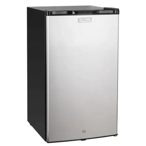 A sleek, stainless steel Fire Magic compact refrigerator with a black top. The refrigerator is standing upright on a white background. It has a single door with a handle and a built-in lock.