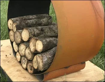 Circular steel firewood rack filled with logs. The rack is resting on a wooden platform.