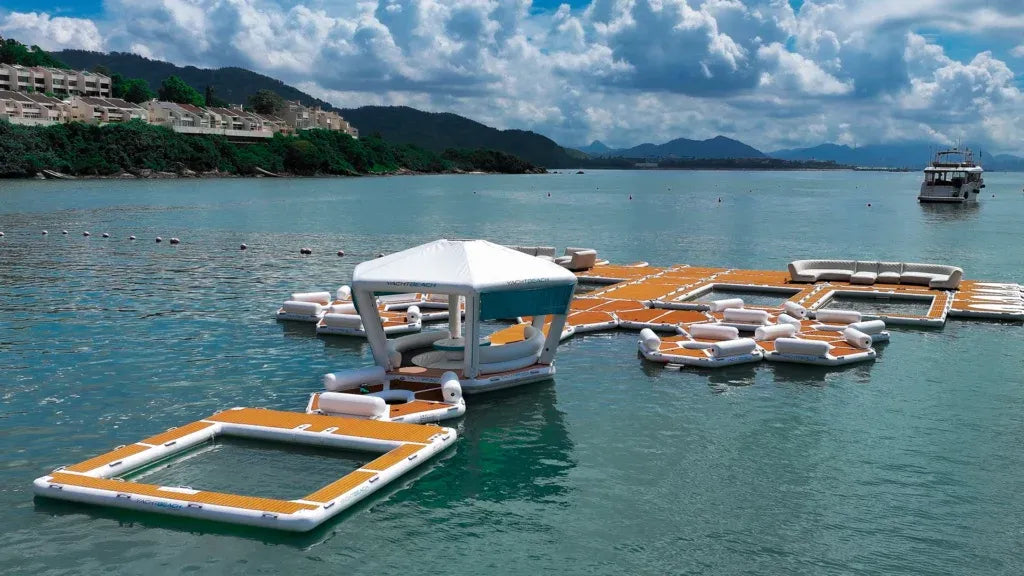 Floating dock with lounge chairs on a calm lake with mountains in the background