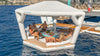 Inflatable floating platform with people on a body of water