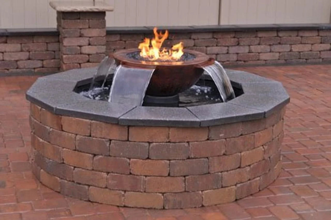 Black, round fire pit with a water feature. The fire pit has a hammered copper fire bowl with flames flickering in the center. Cascading water flows down the sides of the fire pit from a hidden basin.