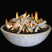 white concrete fire pit bowl with lava rocks and fire logs inside fire pit. Fire pit is lit and pure white fire logs are burning with yellow and orange flames