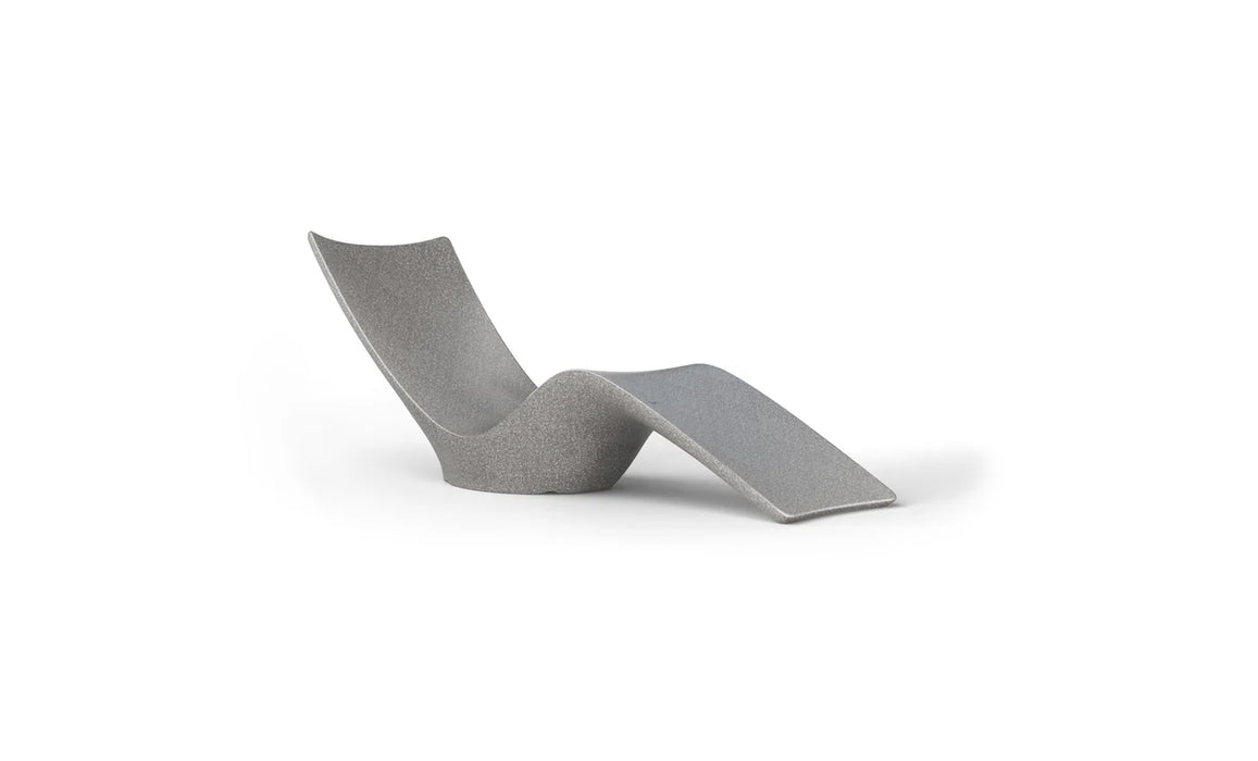 Modern, sculptural chaise lounge in a textured gray material with a curved, flowing design, isolated on white.