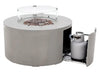 A gray, cylindrical gas fire pit with a clear, round glass wind guard and an open side panel revealing a gray propane tank.