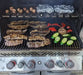 A grill filled with a delicious spread of grilling options, from juicy steaks and veggies to warm potatoes.