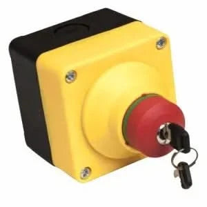 A yellow emergency stop box with a red button and a key inserted. The text on the box says "HPC 120VAC/24VAC Commercial Emergency Stop".