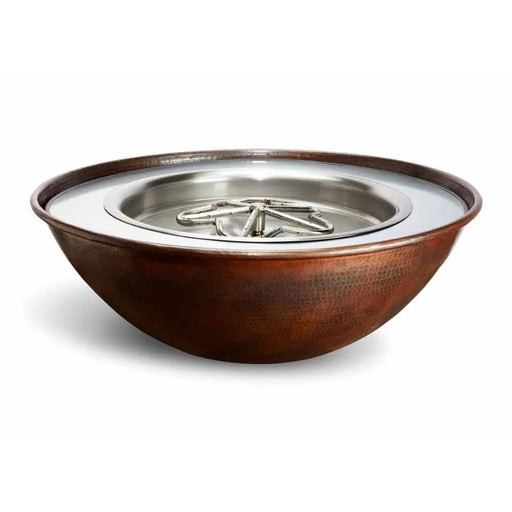 A close-up of a round, hammered copper fire pit bowl lid with a curved handle. The lid is a shiny copper color and has a smooth, hammered surface. Text on the lid reads "HPC Fire Tempe Hammered Copper Gas Fire Pit Bowl Lid. Sold Separately. Email us at sales@luxyardandhomes.com