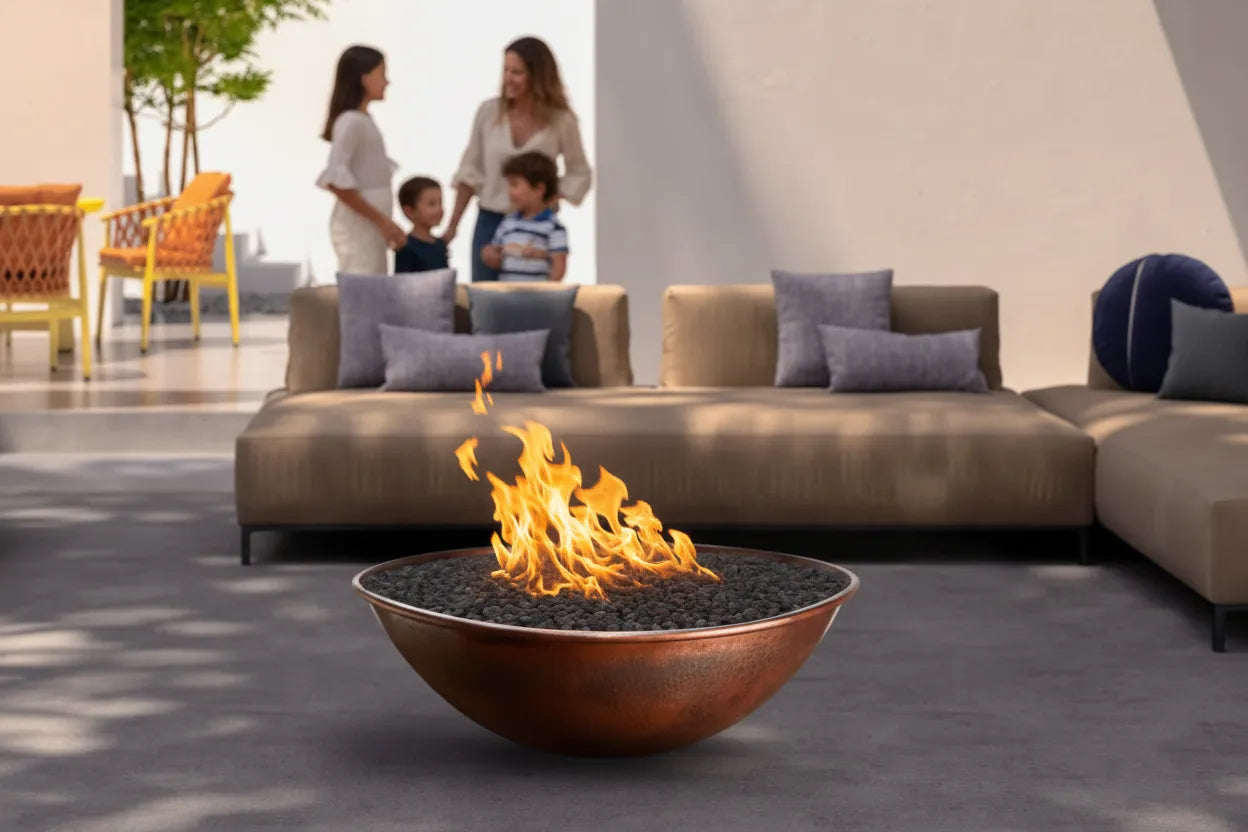 Tempe hammered copper fire bowl with bronze patina and lava rock flames on modern outdoor patio with contemporary furniture