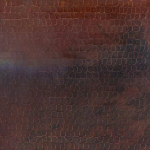 Image of a close-up of a hammered copper surface with a snakeskin pattern.  