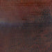 Image of a close-up of a hammered copper surface with a snakeskin pattern.  