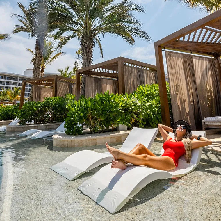 A white Ledge Lounger Signature Standard Side in pool Table, designed for use in and around the pool. It has a sturdy base and a smooth, flat surface.