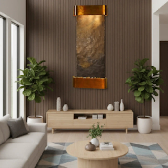 Modern living room with a wooden TV stand, sofa, and decorative wall mounted water feature by adagio