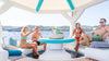 Group of people enjoying a boat trip with drinks and snacks on a sunny day inside a large inflatable float