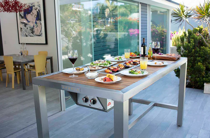 Outdoor dining korean grill table with food and drinks on a patio