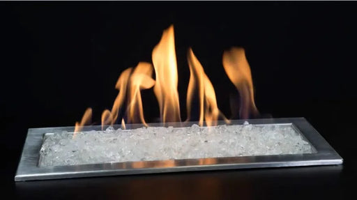 krystallo diamond fire pit glass is burning in fire pit and blowing yellow and orange flames on a black background