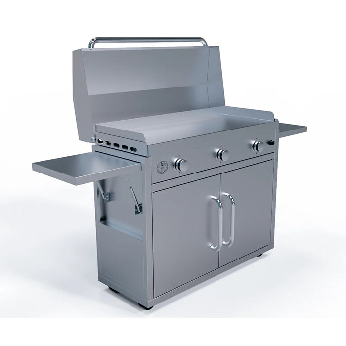 A stainless steel outdoor kitchen station with a built-in gas griddle. The griddle has three burners and control knobs, and a stainless steel lid is open on top. The station has two doors for storage and two folding side shelves.