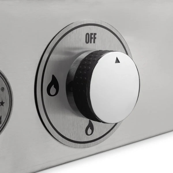 A close-up of a silver gas griddle burner control knob. The knob is round with a black center and a white indicator pointing towards the "OFF" position.