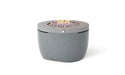 Ledge Lounger Halo 40-inch Outdoor Propane Fire Pit in a gray speckled finish, ignited with a flame burning in the center.