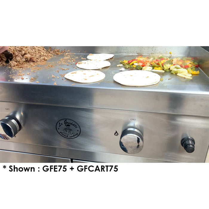 A close-up of a Le Griddle with food cooking on it. There are tortillas, chopped vegetables, and shredded meat on the hot surface. The griddle has two control knobs and a logo.