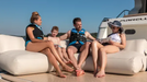 Family sitting on a boat with Marelli branding in the background