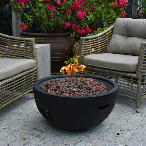 round propane fire bowl with fire pit burning on lava rocks in outside patio