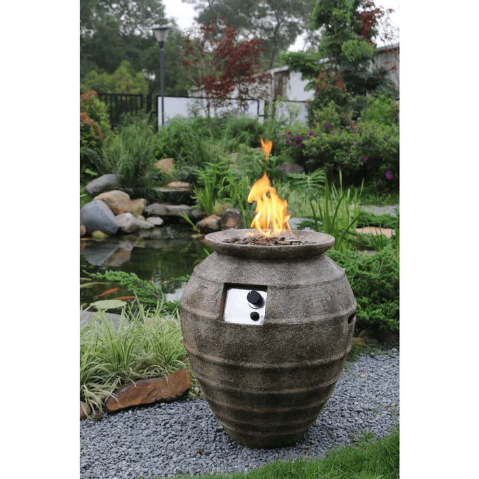 oval concrete fire pit column hidden propane storage is lit on lava rocks