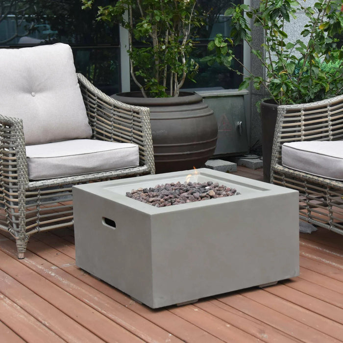 square fire pit table with lava rocks in the middle of fire pits