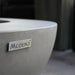 modeno logo on round fire pit table close up