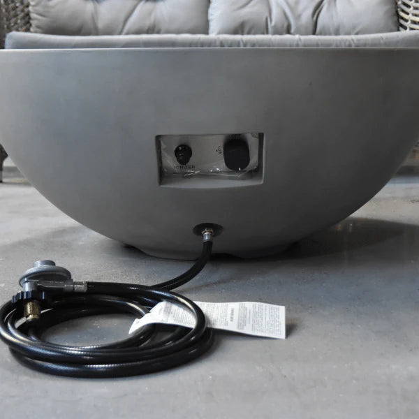 light grey round fire pit table with start stop ignition and hose close up