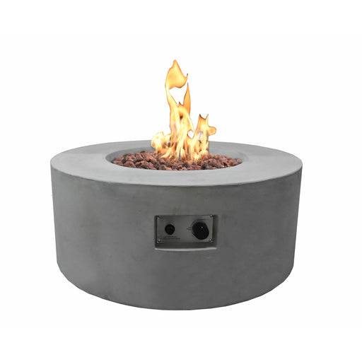 light grey round fire pit table is lit on brown lava rocks with clear view of start and stop button of fire pit on a white background