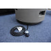 light grey small round fire pit table with 10 ft long black hose close up view