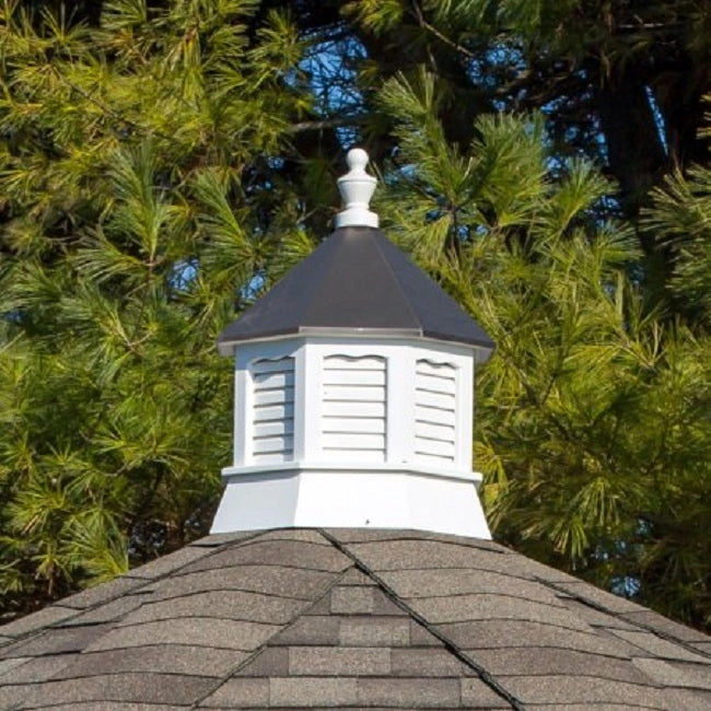  A white octagonal vinyl cupola with a bronze metal roof and a decorative finial.