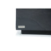 A detailed view of the corner of a black patio coffee table, showcasing the Elementi brand plaque.