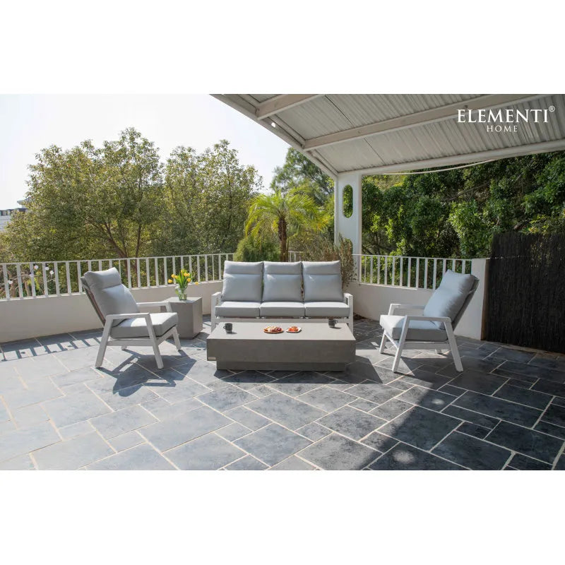 Grey and white Elementi outdoor patio set with a rectangular coffee table on a covered patio.