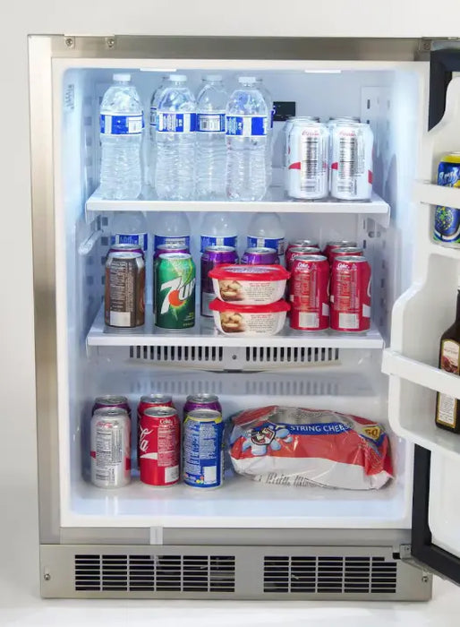  The interior of a stainless steel Fire Magic outdoor refrigerator. The refrigerator is well-stocked with various beverages and snacks, including bottles of water, cans of soda, and bags of chips. The interior is brightly lit with LED lights.