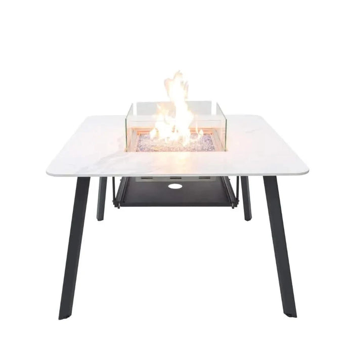 4 seater outdoor dining table with fire pit lit and glass windscreen on a white background