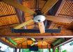 Ceiling view showing two electric patio heaters installed alongside ceiling fans, creating a comfortable outdoor living space.