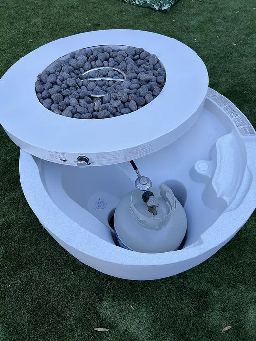 Close-up view of the Ledge Lounger Halo propane Fire Pit with hidden tank storage with a lid that covers tank compartment. The lid is open to show how it works and where the propane tank stays.