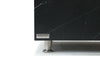Close-up of the Elementi logo on a dark marble-like coffee table.