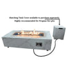 A white rectangular fire pit table with a glass enclosure. The fire pit is burning with a small flame. There is a propane tank and cover next to the table.