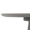A close-up, side view shows the edge of a round, light grey tabletop. The tabletop has a smooth, slightly curved edge. Below the tabletop, a portion of a supporting structure, also in light grey, is visible. 