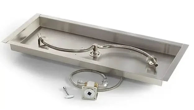 A close-up photo of a rectangular stainless steel gas fire pit burner with an S-shaped design. The burner has small holes drilled along its length.