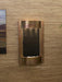 indoor wall fountain hung on passage. copper frame with featherstone backdrop and white pebbles.