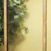 A close-up shot shows water flowing down the textured glass panel of the Adagio Harmony River water feature in a clear glass surface 